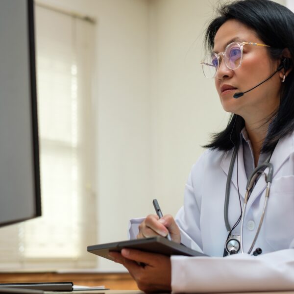 asian woman doctor visit patient video call online diagnose symptom at clinic asian woman doctor visit patient video call online diagnose symptom at clinic